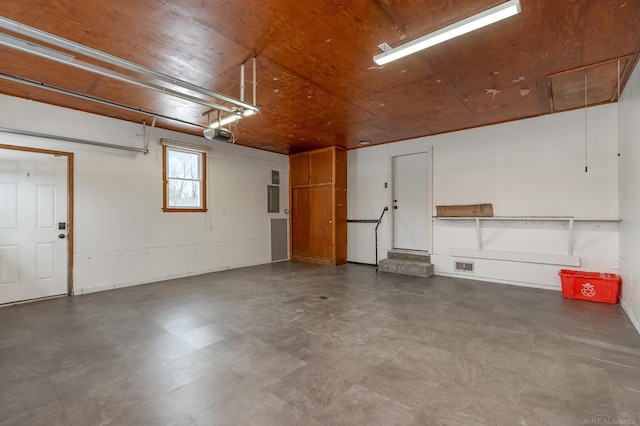 garage featuring wooden ceiling and visible vents