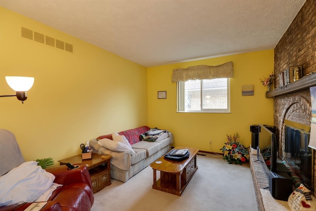 carpeted living room with visible vents, a fireplace, and a textured ceiling