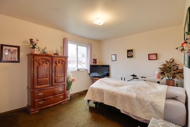 bedroom featuring baseboards and dark carpet