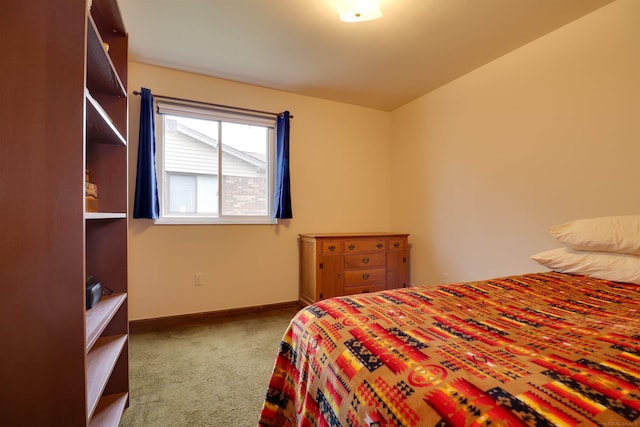 carpeted bedroom featuring baseboards