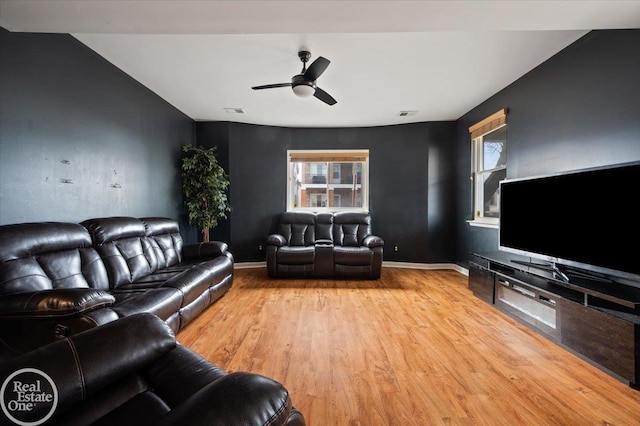 living area with ceiling fan, visible vents, baseboards, and wood finished floors