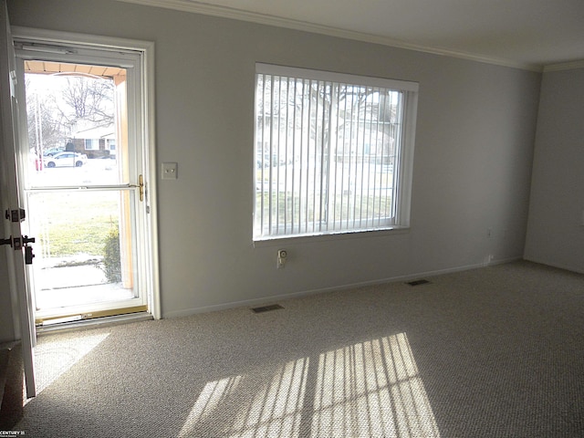 interior space with ornamental molding, visible vents, and plenty of natural light