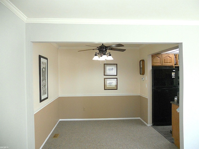 spare room with baseboards and crown molding