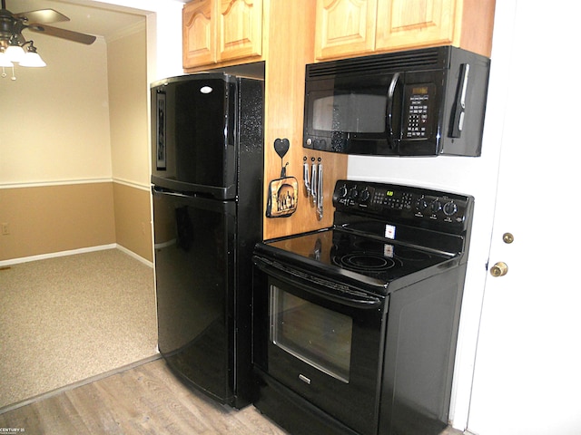 kitchen featuring light wood-type flooring, baseboards, ceiling fan, and black appliances