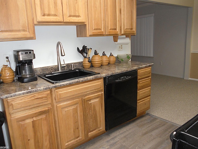 kitchen featuring light wood-type flooring, dishwasher, and a sink