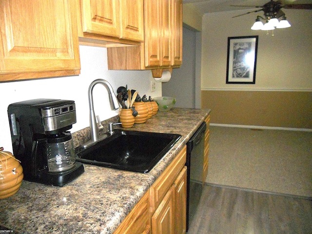 kitchen featuring a ceiling fan, a sink, dishwasher, and wood finished floors