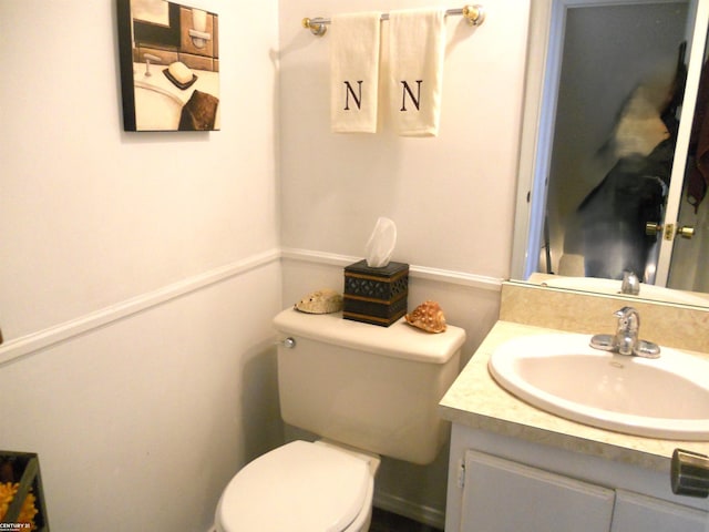 bathroom featuring vanity and toilet