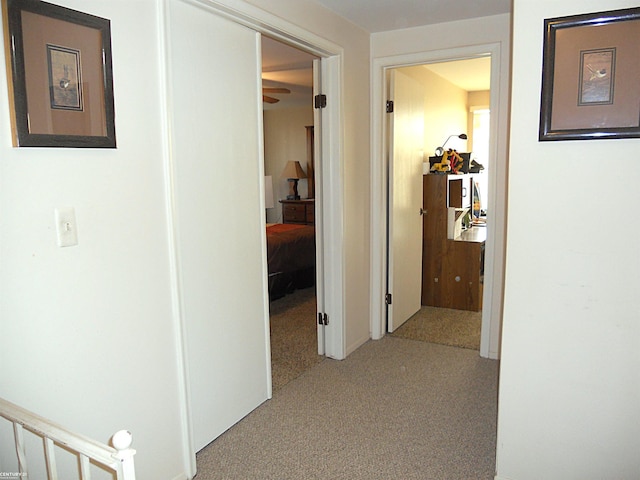 corridor featuring stairs and carpet floors