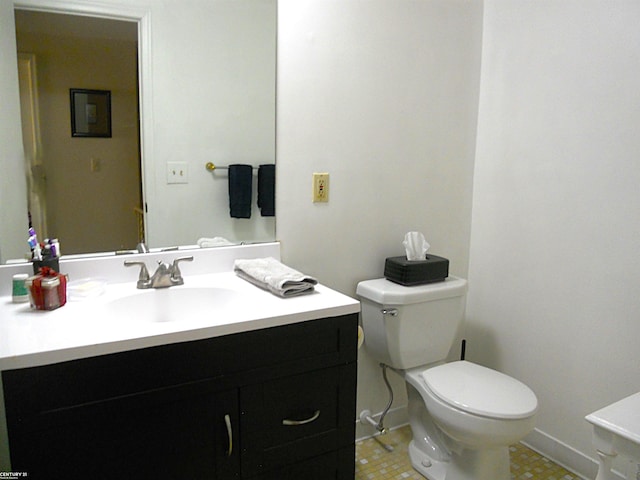 half bath featuring vanity and toilet