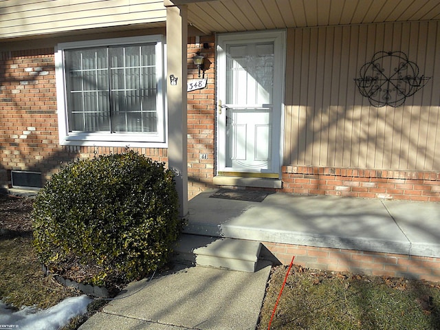 entrance to property with brick siding