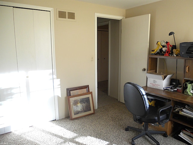 office area featuring visible vents and carpet flooring