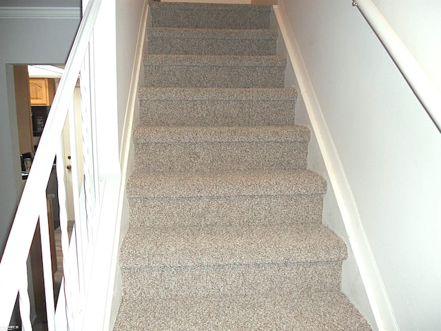 stairway with crown molding