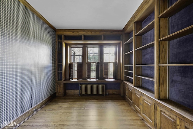 empty room with radiator and hardwood / wood-style floors