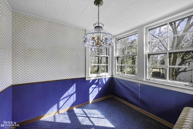 unfurnished sunroom featuring radiator and a notable chandelier