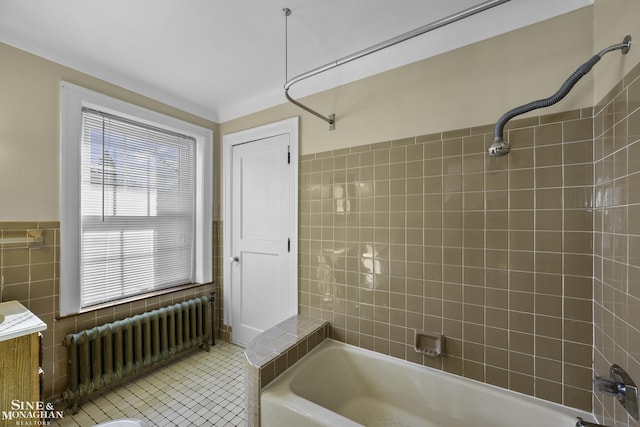 bathroom with shower / tub combination, tile walls, radiator heating unit, and tile patterned floors