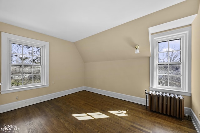 bonus room with radiator heating unit, baseboards, vaulted ceiling, and wood finished floors