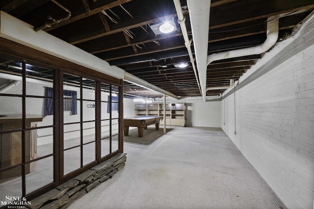 interior space featuring brick wall and pool table