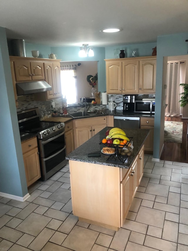 kitchen with stainless steel appliances, tasteful backsplash, light brown cabinetry, a sink, and under cabinet range hood