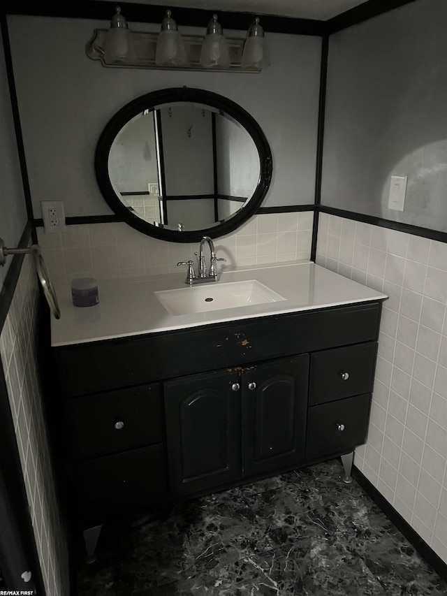 bathroom featuring vanity and tile walls