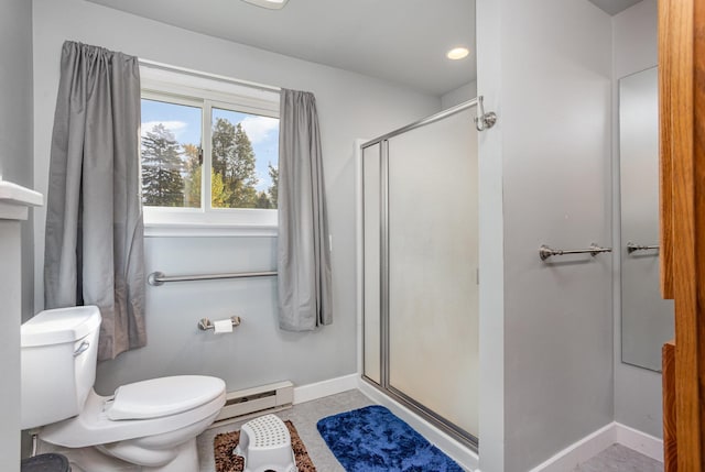 full bath with baseboards, toilet, tile patterned floors, baseboard heating, and a shower stall