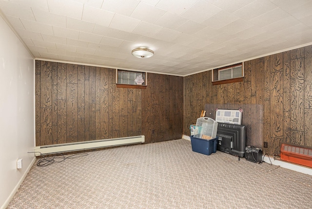 finished basement with baseboards, carpet flooring, wooden walls, and baseboard heating