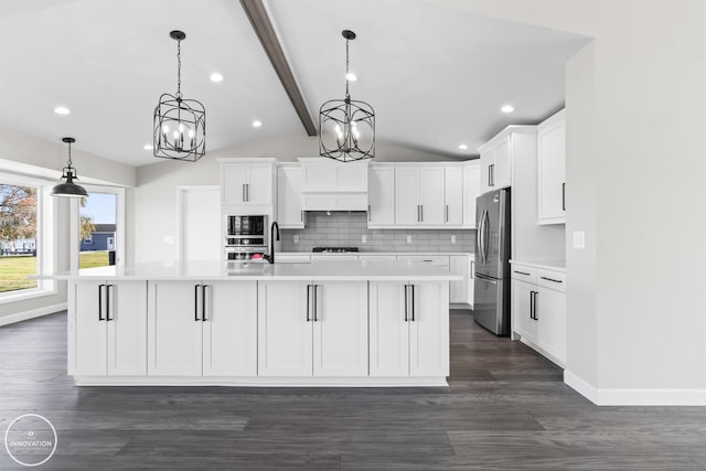 kitchen featuring decorative backsplash, lofted ceiling with beams, freestanding refrigerator, light countertops, and black microwave