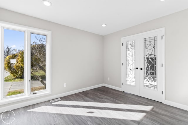 foyer featuring french doors, plenty of natural light, visible vents, and baseboards