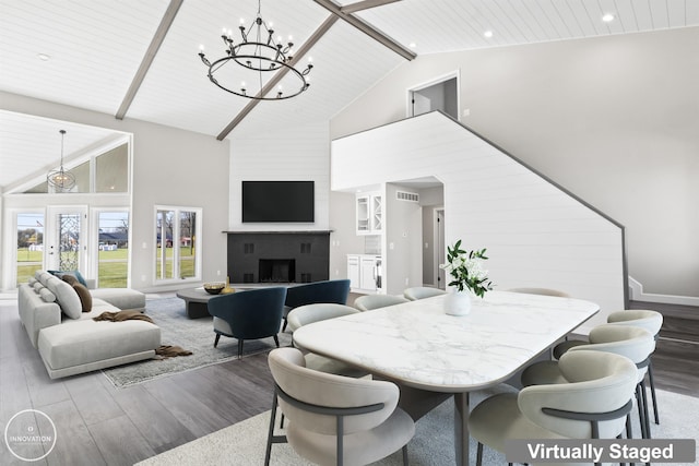 1600 N Channel Dr, Harsens Island, MI 48028 - dining room featuring high vaulted ceiling, a chandelier, wood finished floors, a large fireplace, and beamed ceiling