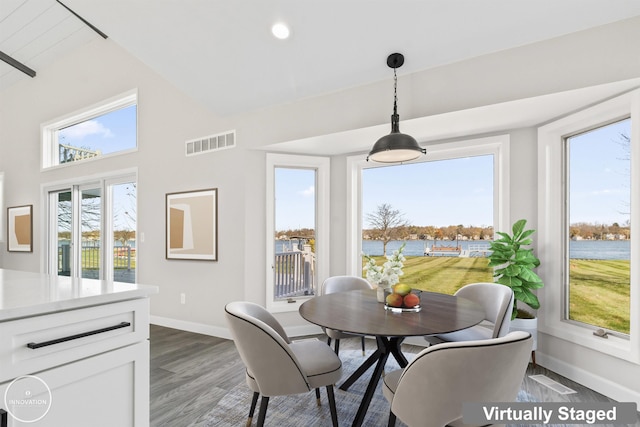 1600 N Channel Dr, Harsens Island, MI 48028 - dining area with baseboards, wood finished floors, a towering ceiling, and recessed lighting