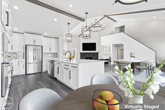 1600 N Channel Dr, Harsens Island, MI 48028 - kitchen with appliances with stainless steel finishes, a sink, dark wood-style flooring, beamed ceiling, and light countertops