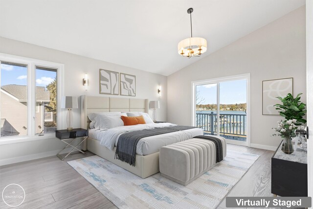 1600 N Channel Dr, Harsens Island, MI 48028 - bedroom with access to exterior, light wood finished floors, a chandelier, baseboards, and vaulted ceiling