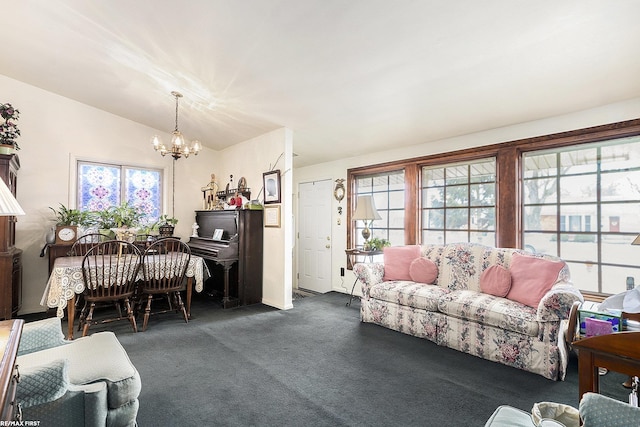 living room featuring lofted ceiling, dark colored carpet, and an inviting chandelier