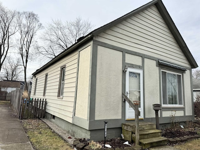 view of side of home with fence