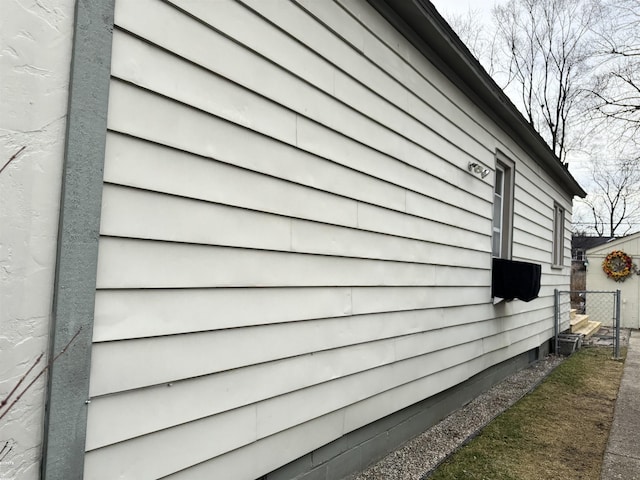 view of home's exterior featuring fence