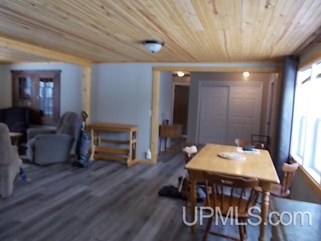 dining area featuring wooden ceiling, a wealth of natural light, and wood finished floors