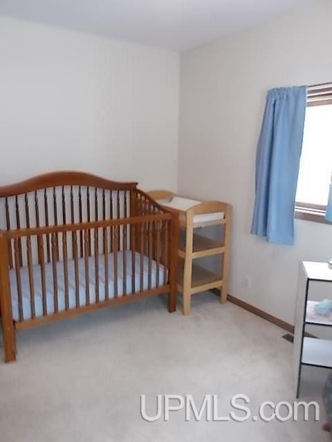 bedroom with carpet floors and baseboards