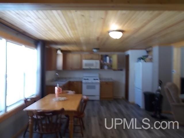 dining space featuring wood ceiling and wood finished floors