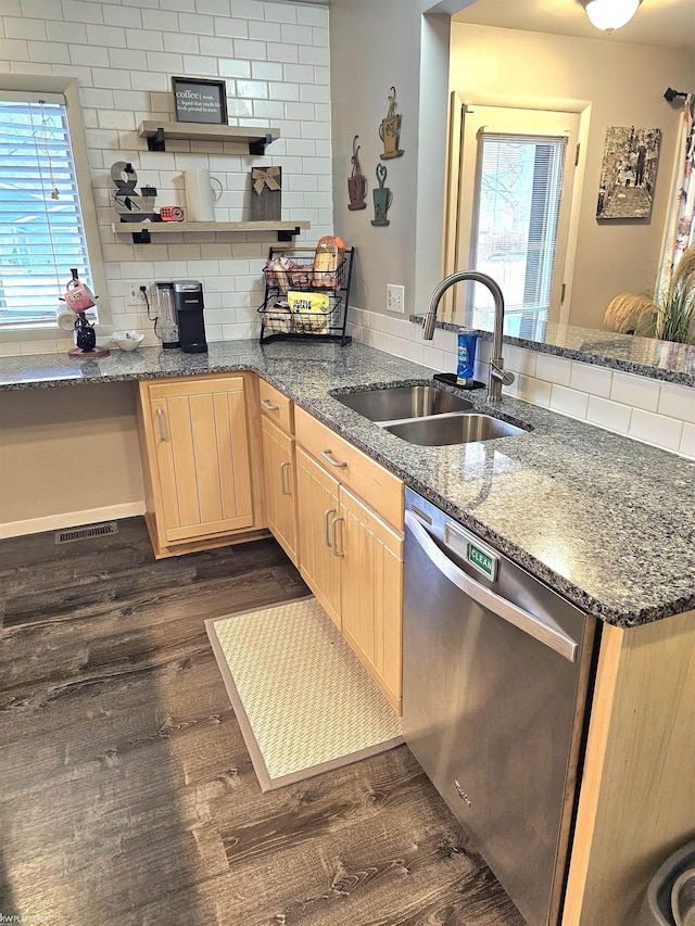 kitchen with dark wood finished floors, light brown cabinets, a sink, dishwasher, and a peninsula