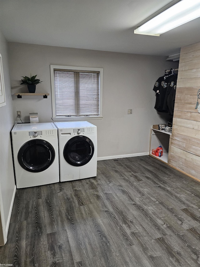 laundry area featuring laundry area, independent washer and dryer, wood finished floors, and baseboards