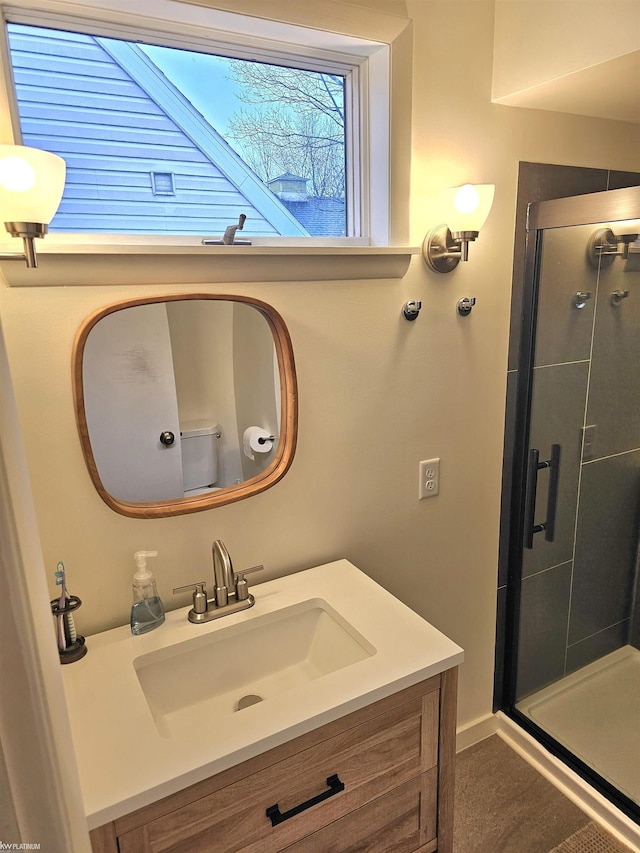 full bath with a shower stall and vanity