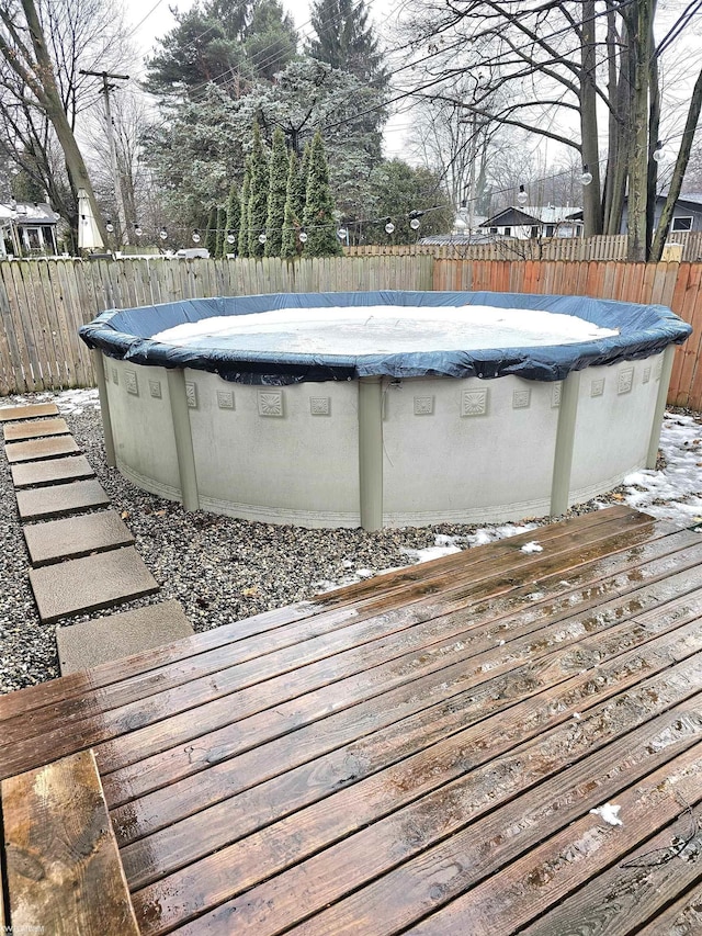 view of pool featuring a fenced backyard, a fenced in pool, and a wooden deck