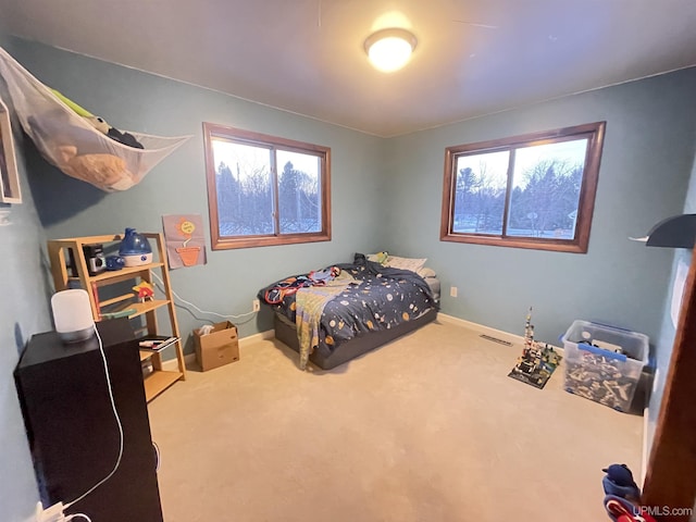 bedroom with carpet floors and baseboards