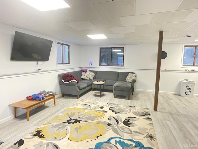 living area with baseboards and wood finished floors