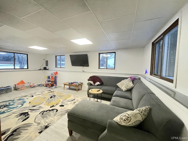 living room featuring a drop ceiling and wood finished floors