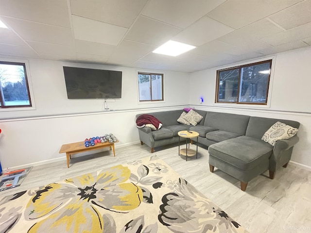 living room with a healthy amount of sunlight, baseboards, and wood finished floors