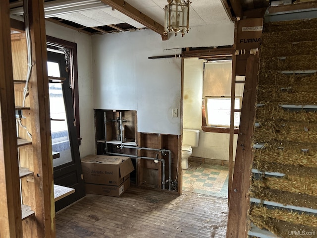 interior space featuring hardwood / wood-style floors and beamed ceiling