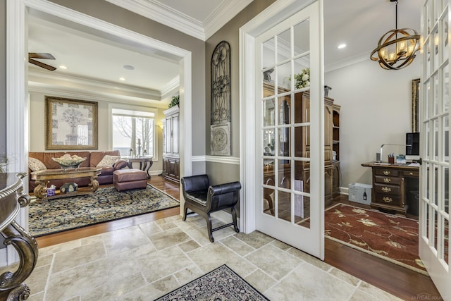 sunroom / solarium featuring ceiling fan with notable chandelier and french doors