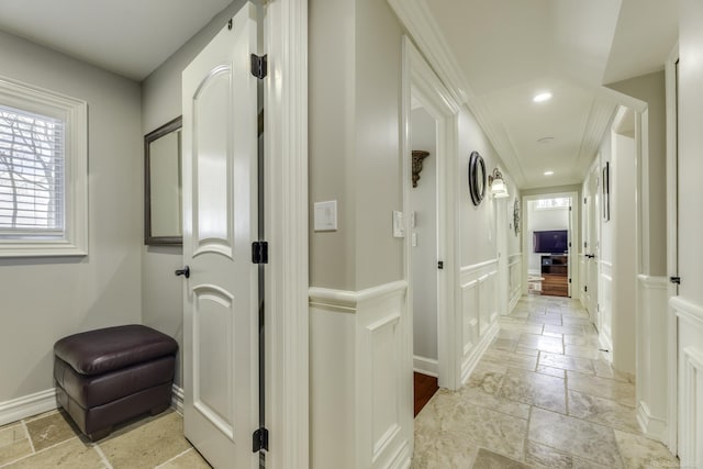 hall featuring stone tile floors, baseboards, and recessed lighting