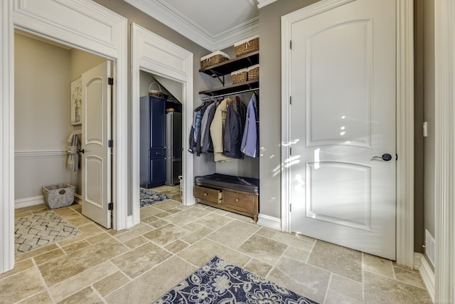 mudroom featuring ornamental molding, baseboards, and stone tile floors