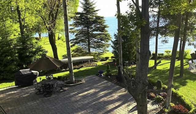 view of patio / terrace featuring outdoor dining space and a water view